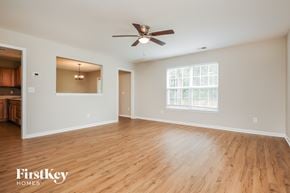 Ladson house for rent - A spacious room with wooden flooring and a ceiling fan.