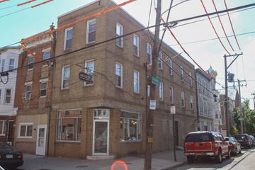 Philadelphia apartment for rent - a brick building on the corner of a city street