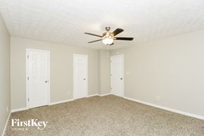 Canton house for rent - a bedroom with two doors and a ceiling fan