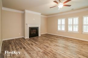 Canton house for rent - a living room with a fireplace and a ceiling fan