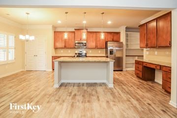 Canton house for rent - a large kitchen with wood floors and wooden cabinets