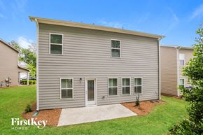 Canton house for rent - a small gray house with a yard and grass