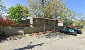 Tacoma apartment for rent - a house with a fence and cars parked in front of it