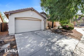 Laveen house for rent - A house with a white garage door is for sale.