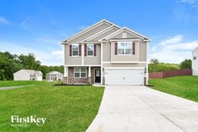 Winston-Salem house for rent - a beige house with a sidewalk in front of it
