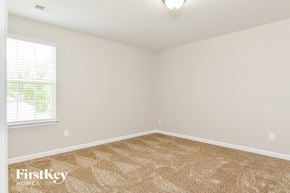 Winston-Salem house for rent - the spacious bedroom with carpeted flooring and a window
