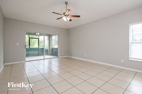 Davenport house for rent - A spacious room with a ceiling fan and sliding glass doors leading to a garden.