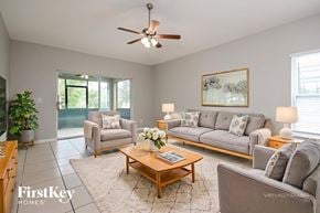Davenport house for rent - A living room with a grey couch, a coffee table, and a ceiling fan.