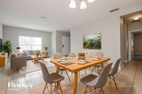 Davenport house for rent - A dining room with a wooden table and chairs.