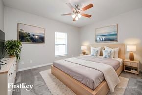 Davenport house for rent - A bedroom with a bed, nightstand, and a ceiling fan.