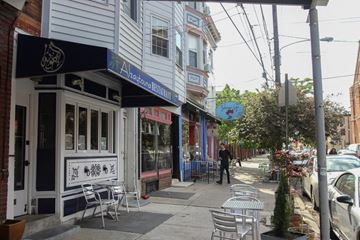 Philadelphia apartment for rent - a man is walking down a sidewalk in front of a restaurant