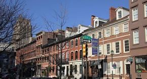 Philadelphia apartment for rent - a row of buildings on a city street with a traffic light