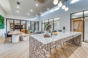 Calgary apartment for rent - A modern dining room with a large table and chairs.