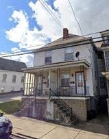 Donora house for rent - a picture of an old house with a car parked in front of it