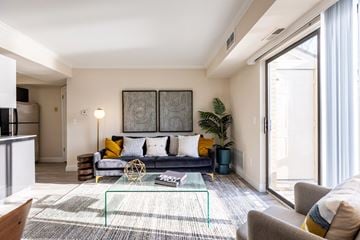 Novi apartment for rent - a living room with a couch and a glass coffee table