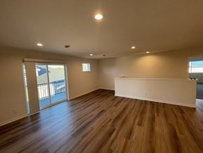 Belgium apartment for rent - A room with wooden floors and a white wall.