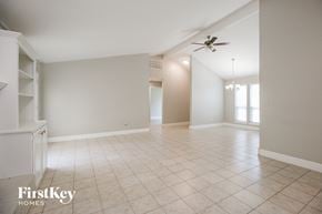 Norman house for rent - A spacious room with a ceiling fan and tiled flooring.