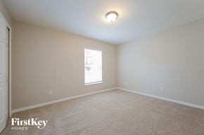 Cape Coral house for rent - a spacious room with white carpet and a window