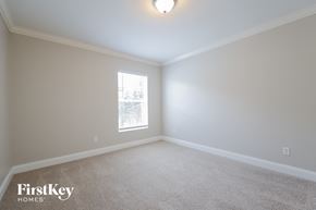 Cape Coral house for rent - a bedroom with a carpeted floor and a window
