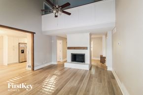 Canton house for rent - a living room with a fireplace and a ceiling fan