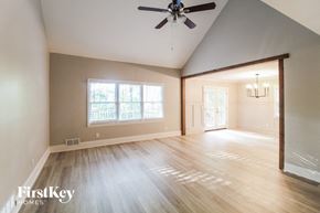 Canton house for rent - the living room and dining room with hardwood floors and a ceiling fan