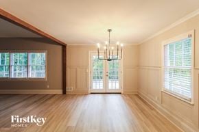 Canton house for rent - an empty dining room with a chandelier and windows