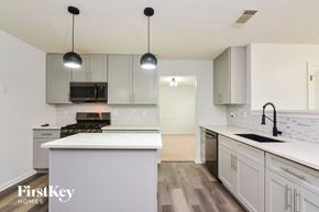 Decatur house for rent - a white kitchen with white counter tops and white cabinets