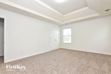 Decatur house for rent - the living room of a home with carpet and a door