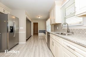Murfreesboro house for rent - a kitchen with white cabinets and a stainless steel refrigerator
