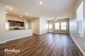 Davenport house for rent - A spacious living room with wooden floors and a kitchen area in the background.