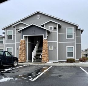 Pasco apartment for rent - A grey building with a black truck parked in front.
