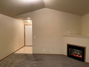 Pasco apartment for rent - A room with a fireplace and a carpeted floor.
