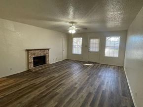 Georgetown apartment for rent - an empty living room with a fireplace and wooden floors