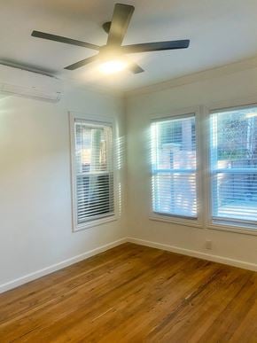 Dallas apartment for rent - an empty bedroom with a ceiling fan and three windows