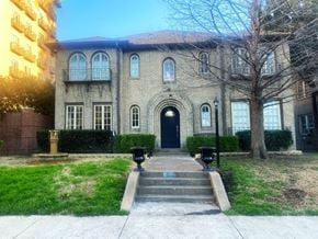Dallas apartment for rent - a large brick building with a black door and stairs