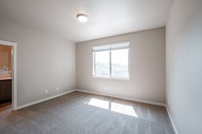 Forest Grove house for rent - an empty living room with a large window and carpet