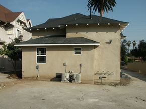 Pasadena apartment for rent - A house with a brown roof and tan walls with a tree in front of it.