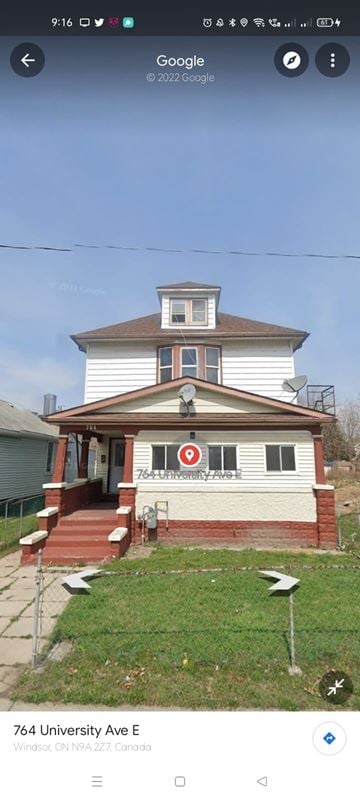 Windsor apartment for rent - A white house with a brown roof and a red sign on the front.