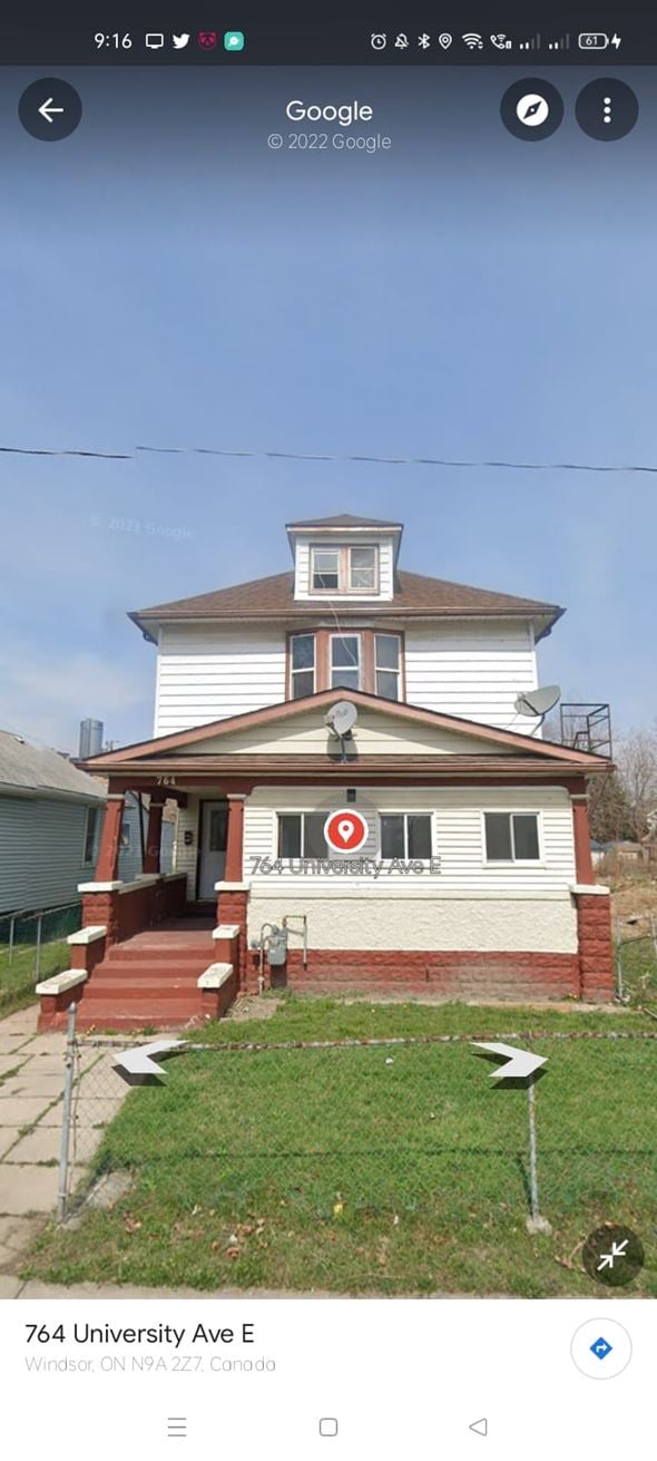 Windsor apartment for rent - A white house with a brown roof and a red sign on the front.