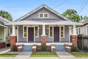 New Orleans apartment for rent - A house with a grey facade and a purple door.
