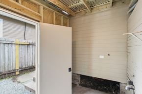 New Orleans apartment for rent - A white door is open to a room with a wooden ceiling.