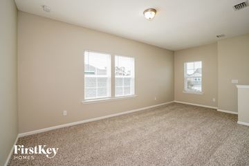 Fleming Island house for rent - a spacious living room with carpet and two windows