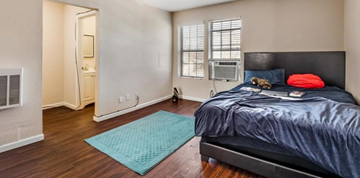 Fort Worth apartment for rent - a bedroom with a bed and a rug