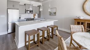 Huntersville apartment for rent - a kitchen with a white counter top and three stools