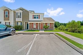 Jacksonville house for rent - A car is parked in a driveway in front of a house.