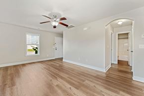 Jacksonville house for rent - A room with a ceiling fan and wooden flooring.