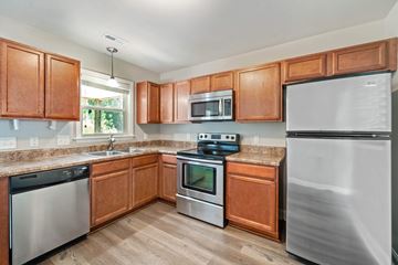 Jacksonville house for rent - A kitchen with wooden cabinets and stainless steel appliances.