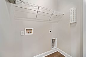 Jacksonville house for rent - A white wall with a shelf and a wire rack above it.