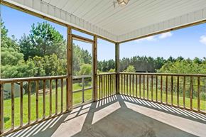 Jacksonville house for rent - A sunny day on a wooden deck with a view of the trees.