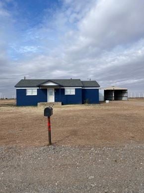 Hermleigh house for rent - a blue house with a mailbox in a field